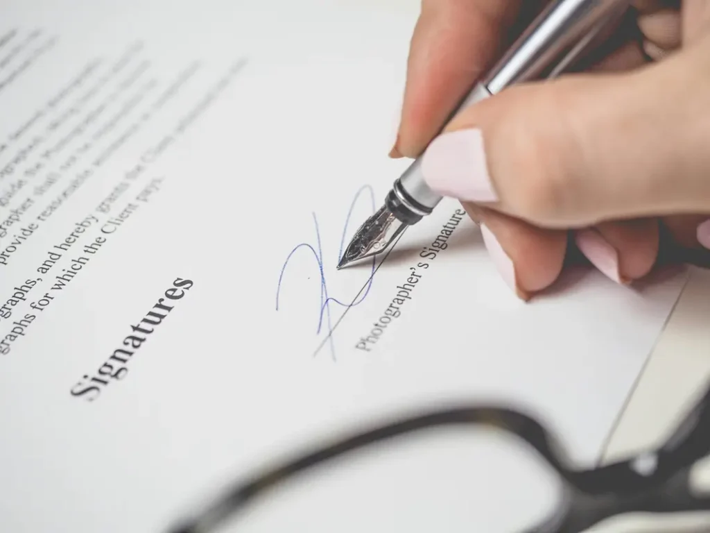 Signing documents after calculating how much house a buyer can afford