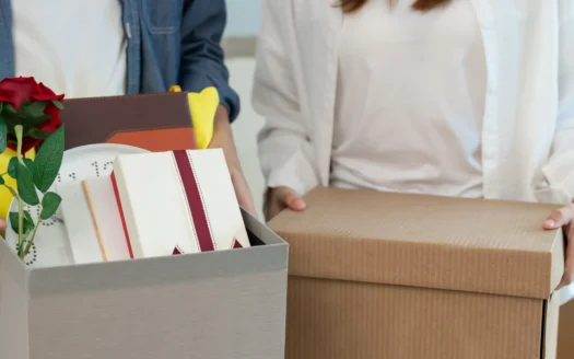 Couple carrying moving boxes