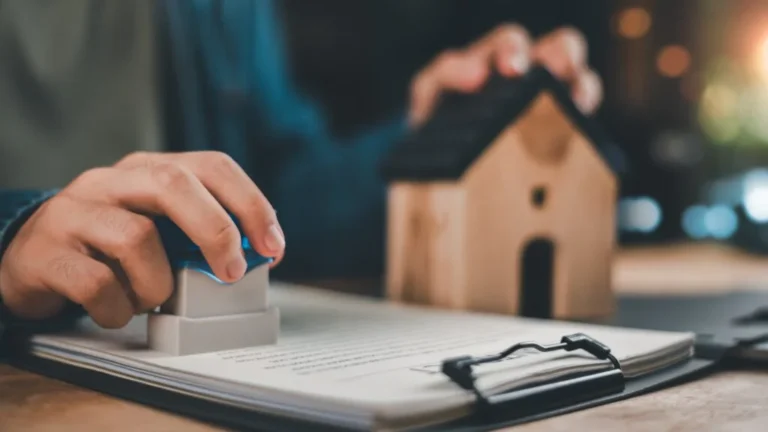 Mortgage and closing documents with house model
